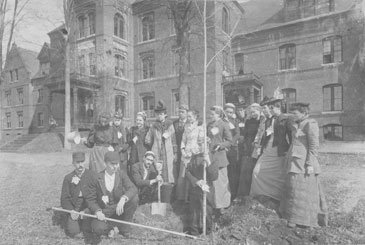 Students planting a tree outside Knowles Hall in the early 1890s