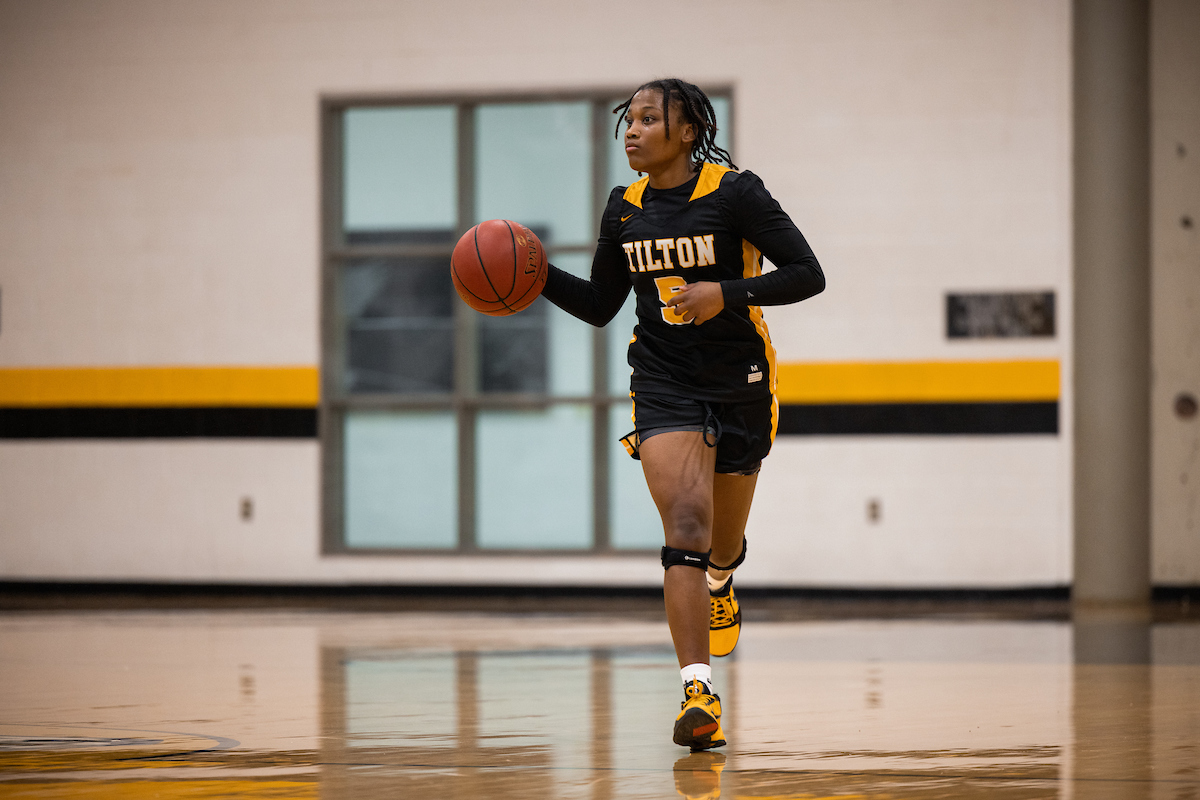 A Tilton girls basketball player dribbles the ball up the court during a New England Prep School Athletics game..