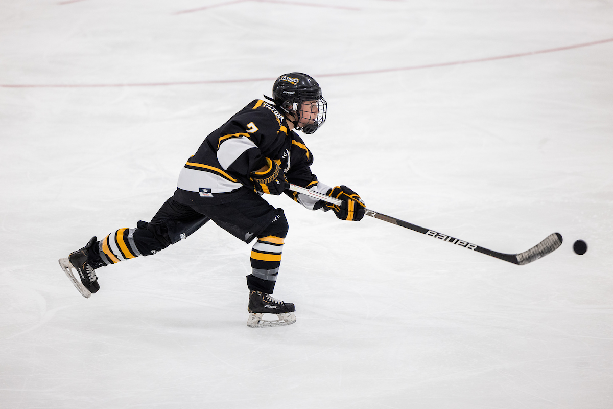 A Tilton girls hockey player passes the puck during a New England Prep School Athletics game..