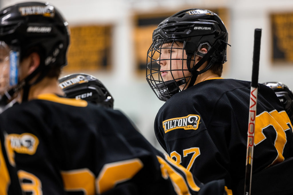 A player looks on as Tilton, a top New England boys prep hockey program, plays a game.