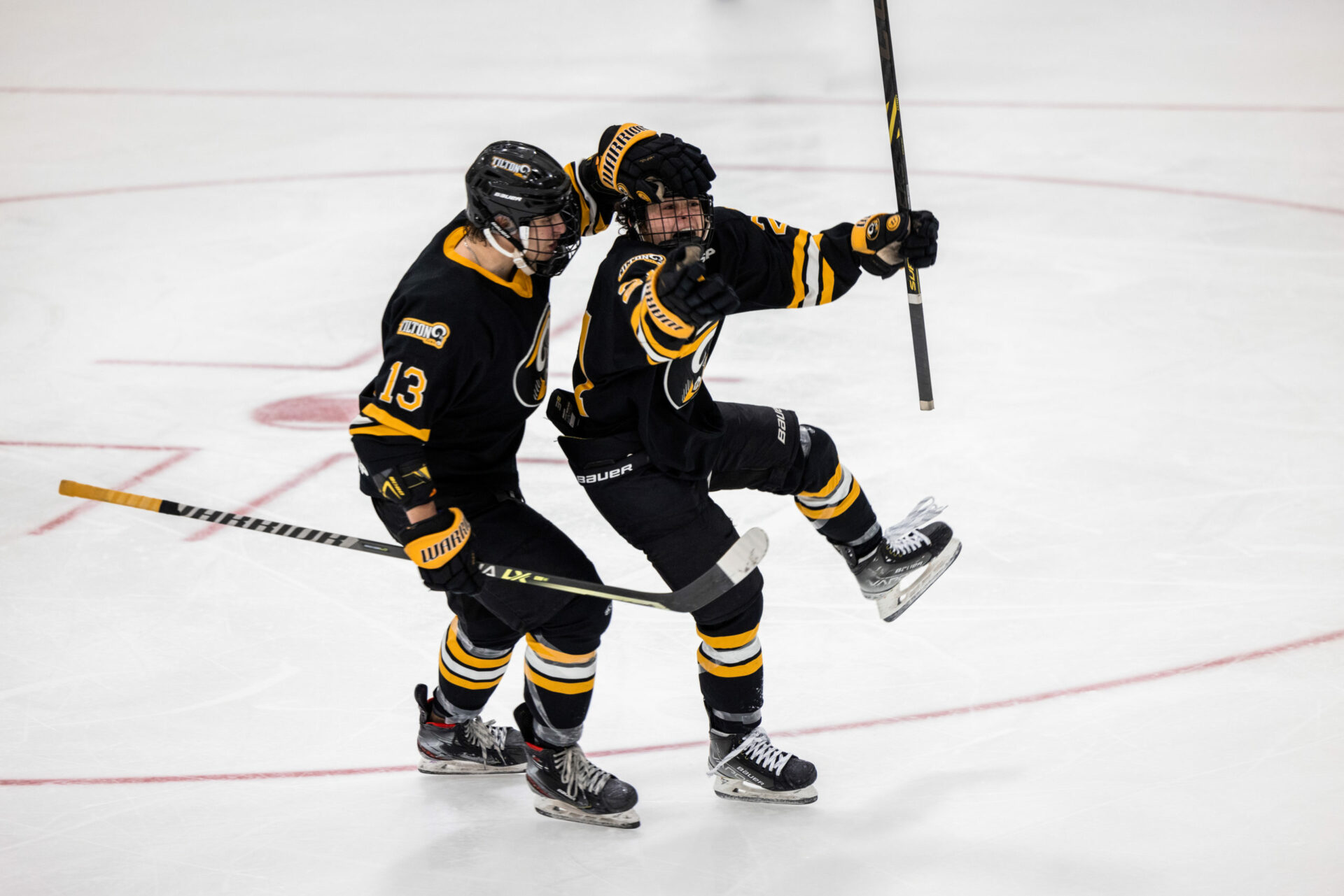 Tilton players celebrating after a goal scored in a New England Prep School Hockey game.