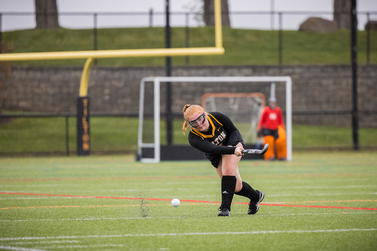 A Tilton field hockey player strikes the ball downfield during a New England Prep School Athletics game..