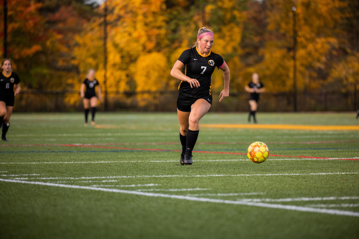 A Tilton School girls soccer player advances the ball up the field during a New England Prep School Athletics contest.