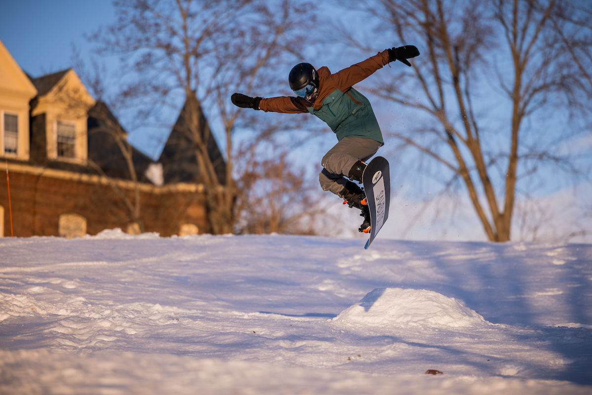 A Tilton snowboarder uses a homemade jump on campus.