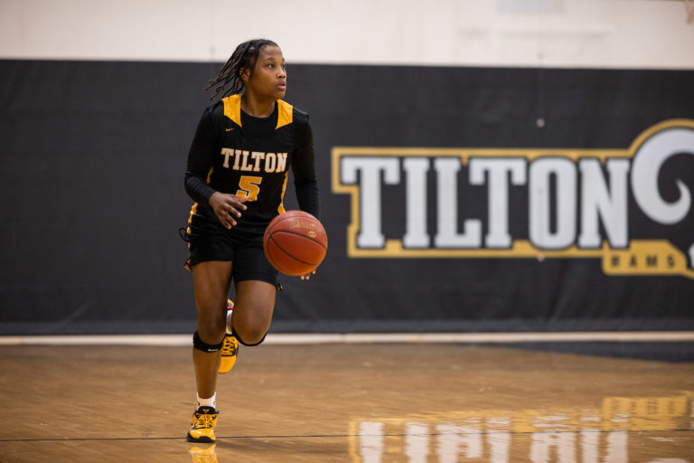 Tilton girls varsity basketball player Ahnay Adams dribbles the ball up the court.