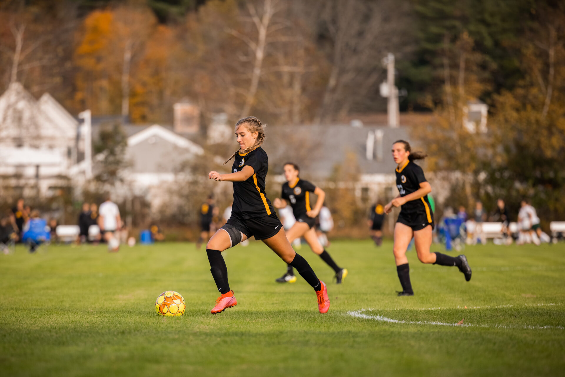 A Tilton School girls soccer player moves the ball downfield.